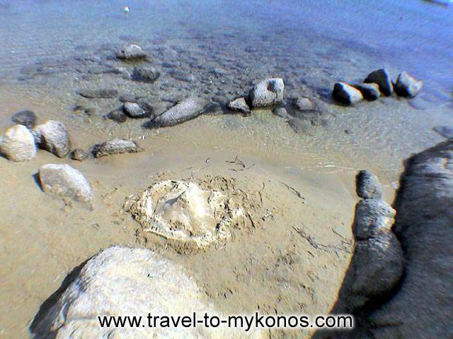 PSAROU BEACH - The wave destroy the tower that had made a child from water and sand..