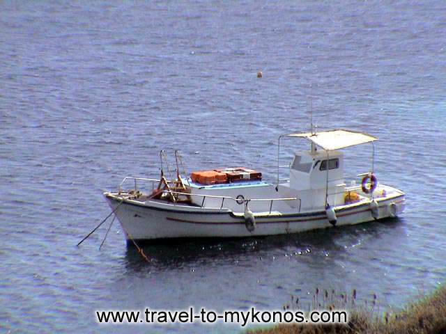 PSAROU BEACH - A fishing boat that has anchor near to the beach.