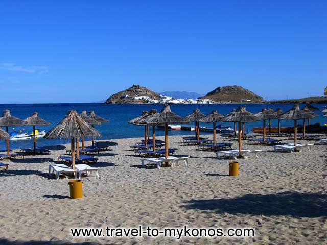 THE BEACH - View of Kalafatis beach at the organised part with the umbrellas and Dibounia (two mountains) in the background.