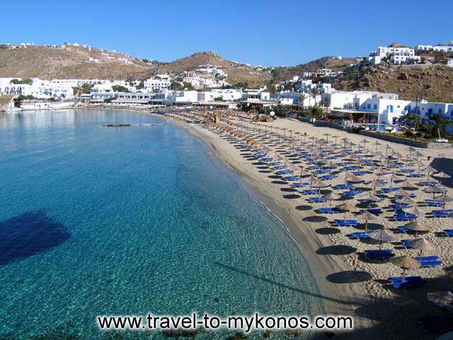 A view of the golden sand, crystal clear water beach of Platis Gialos in Mykonos  