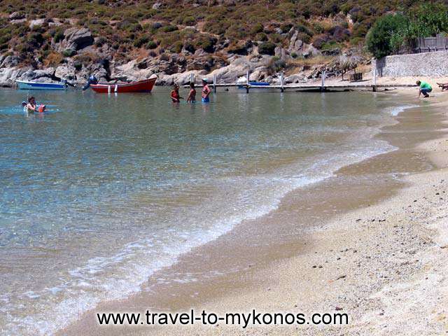 VIEW OF THE BEACH - A couple of boats and some people swimming in the wonderful beach of Psarou